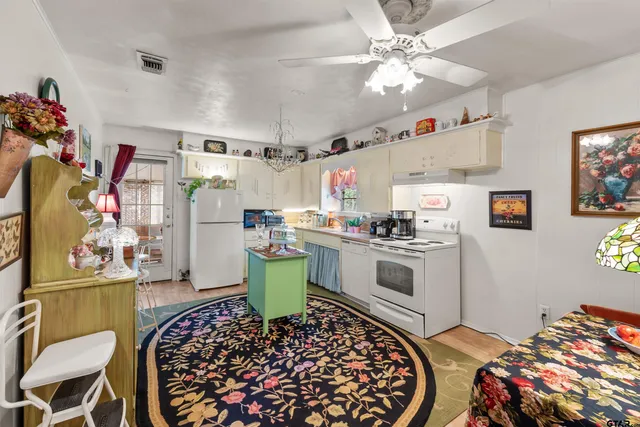 a kitchen with stainless steel appliances kitchen island granite countertop a sink and cabinets