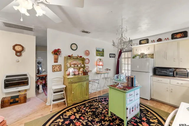 a kitchen with a refrigerator and a stove top oven