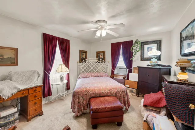a bedroom with 2 bed and a chandelier