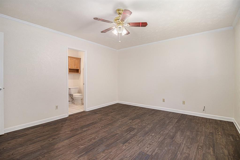 1814 Addington Drive Carrollton, TX 75007 - Photo 14 of 24 Spare room with ceiling fan, crown molding, and dark wood-type flooring