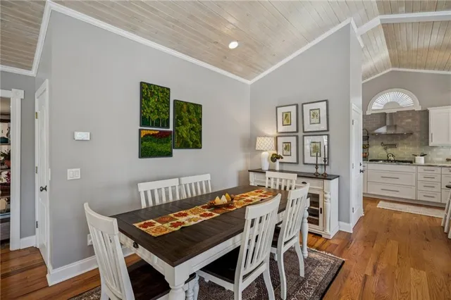 a kitchen with a table chairs refrigerator and cabinets