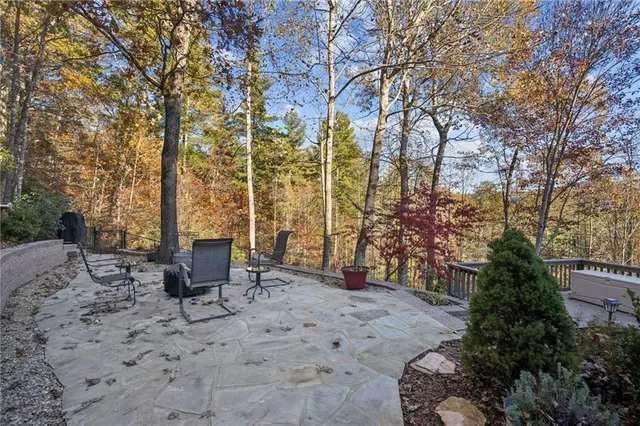 a view of backyard with outdoor seating and trees
