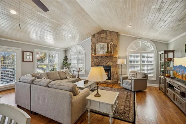 a living room with lots of furniture and wooden floor