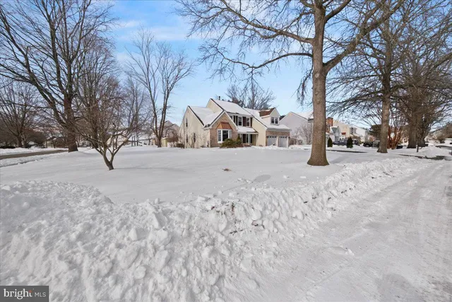 a living room with furniture a wooden floor and next to a window