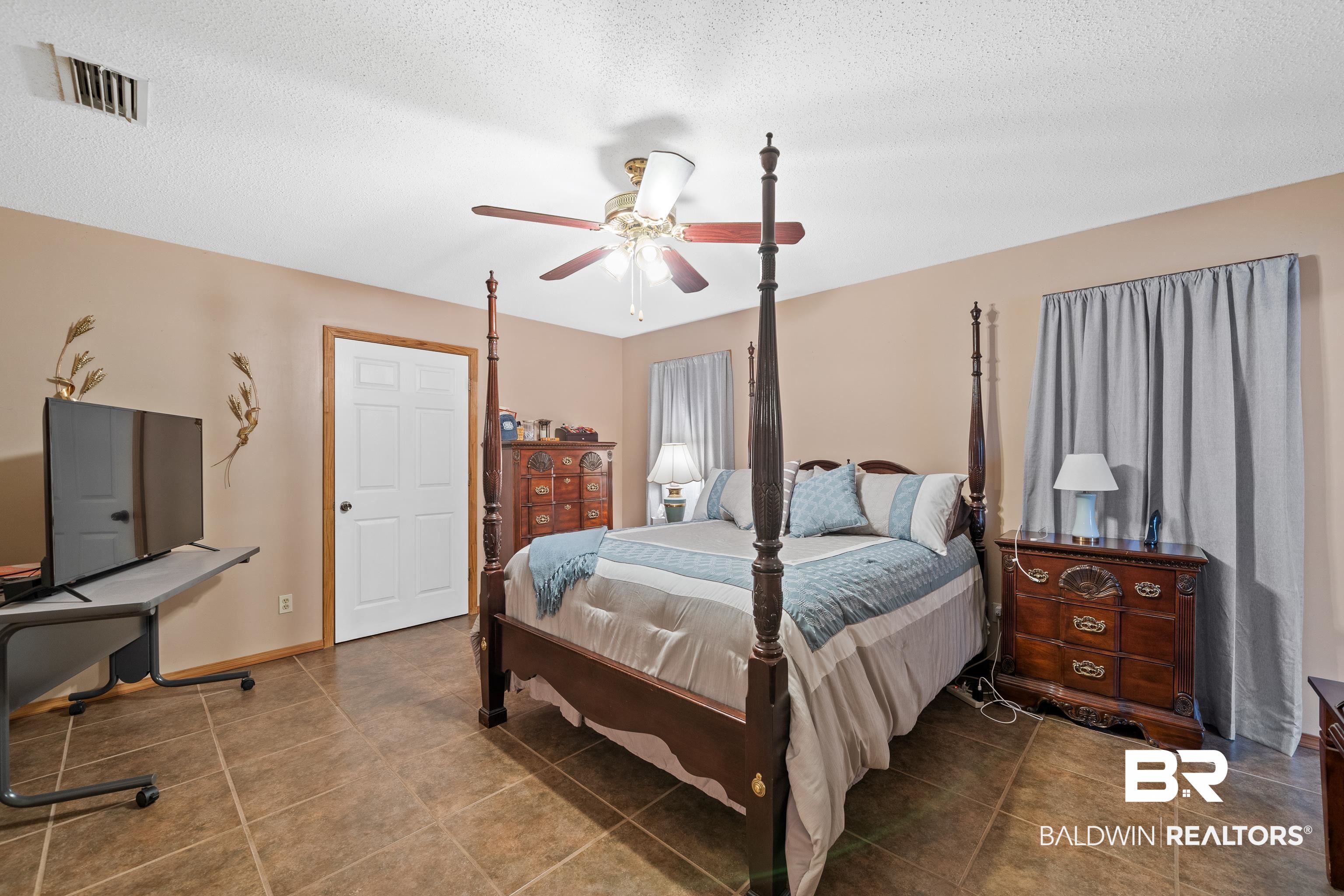 460 Ridgewood Drive Daphne, AL 36526 - Photo 18 of 31 Bedroom featuring ceiling fan and a textured ceiling