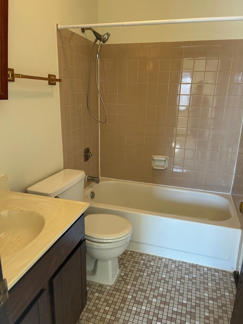 626 Terry Court, Unit A Roselle, IL 60172 - Photo 14 of 15 a bathroom with a sink a toilet a bathtub and shower