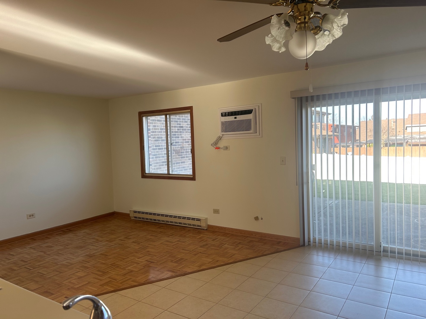 626 Terry Court, Unit A Roselle, IL 60172 - Photo 10 of 15 an empty room with chandelier fan and windows