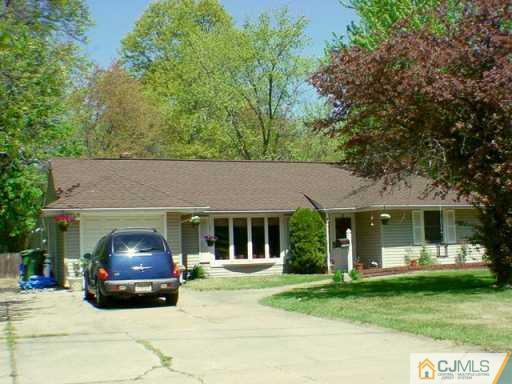 42 Homestead Road Edison, NJ 08820 - Photo 2 of 2 a house that has a tree in front of it
