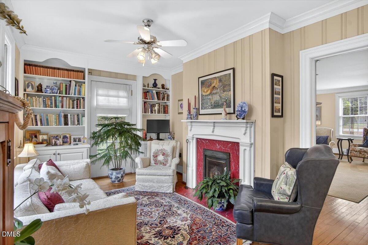 2064 Oxford Road Henderson, NC 27536 - Photo 12 of 68 a living room with furniture a chandelier and a fireplace