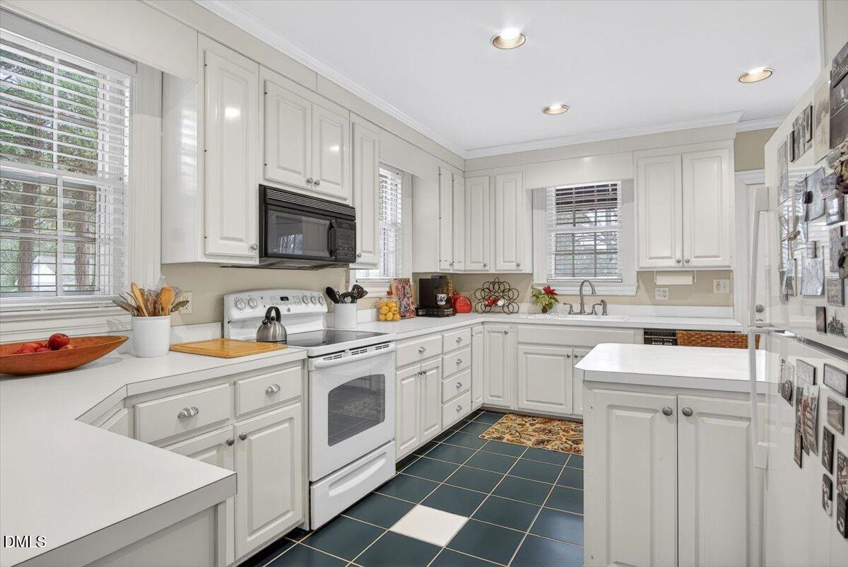 2064 Oxford Road Henderson, NC 27536 - Photo 18 of 68 a kitchen with a sink cabinets and window