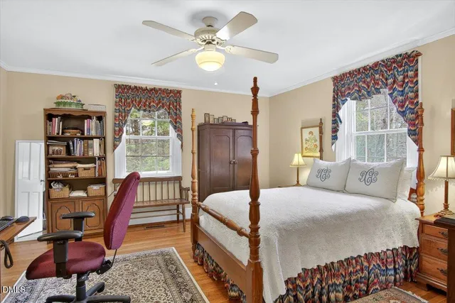 a bedroom with a large bed and a chandelier