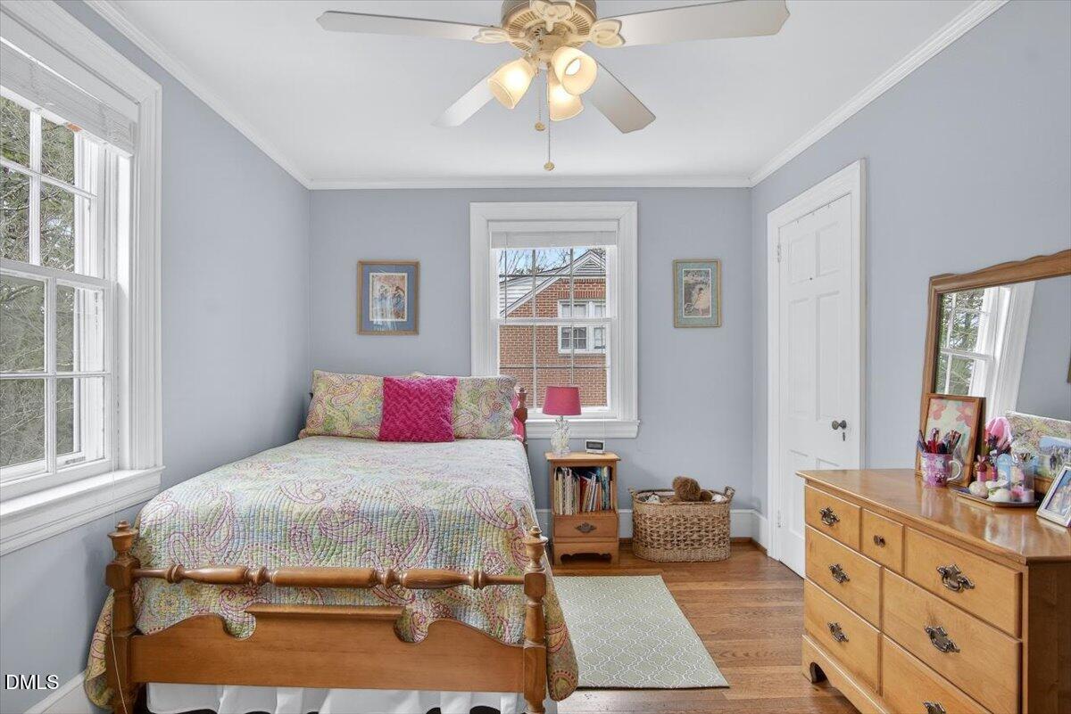 2064 Oxford Road Henderson, NC 27536 - Photo 29 of 68 a bedroom with a large bed and a chandelier