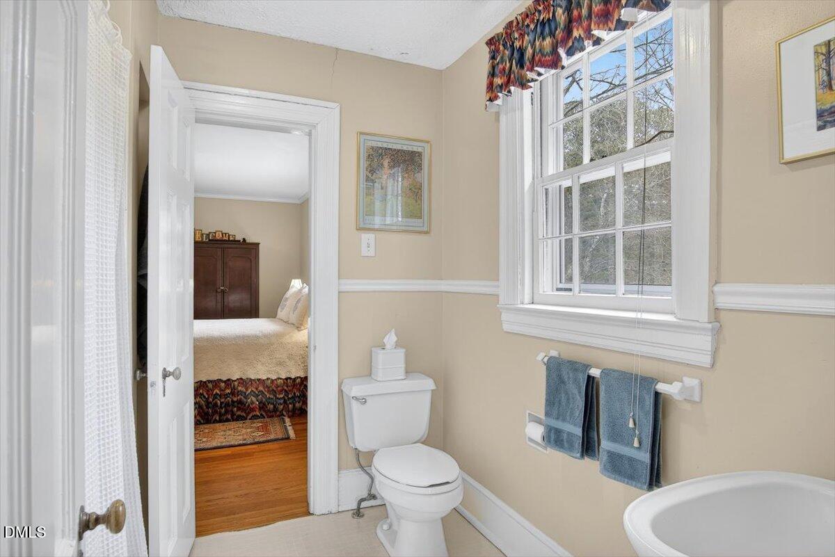 2064 Oxford Road Henderson, NC 27536 - Photo 33 of 68 a bathroom with a toilet and a sink