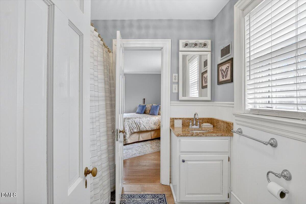 2064 Oxford Road Henderson, NC 27536 - Photo 41 of 68 a bathroom with a sink and a window
