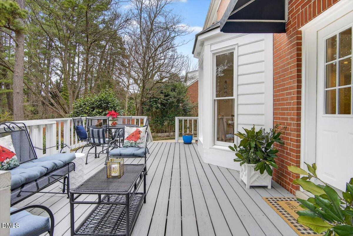 2064 Oxford Road Henderson, NC 27536 - Photo 46 of 68 a view of a deck with couches table and chairs and wooden floor