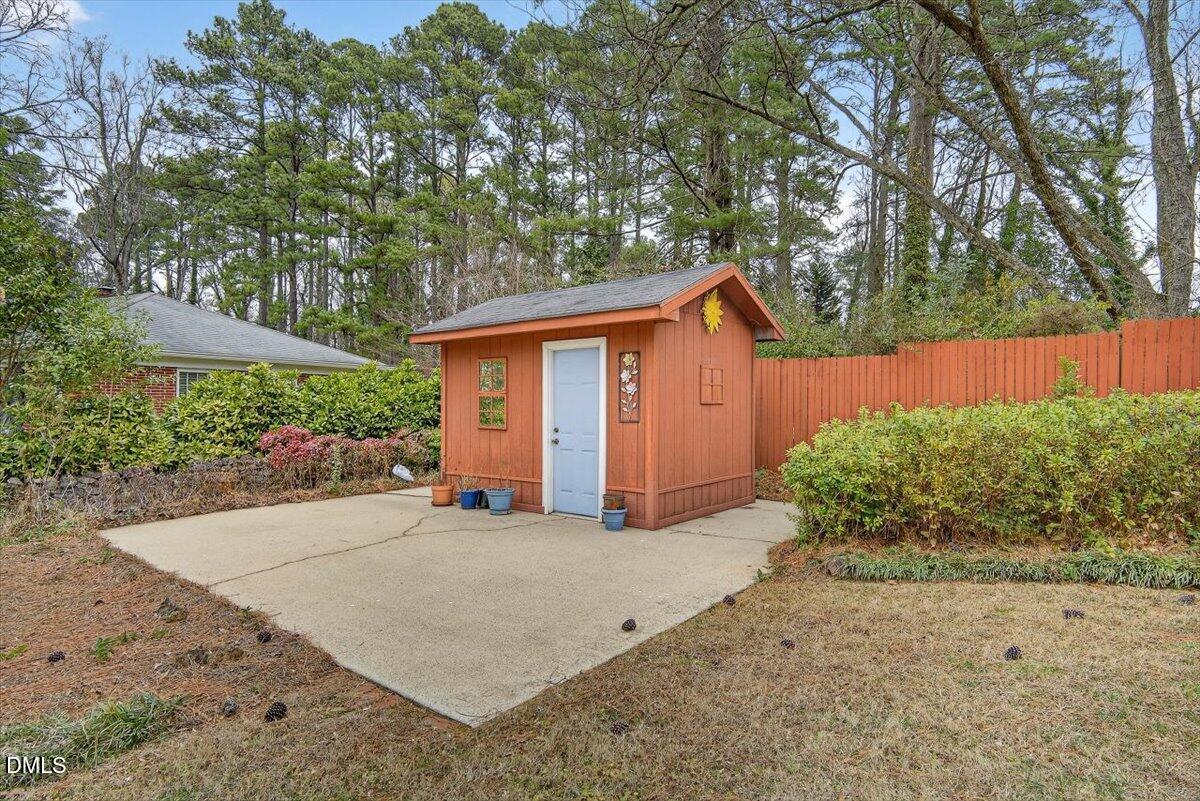2064 Oxford Road Henderson, NC 27536 - Photo 53 of 68 a view of a house with a yard plants and large tree