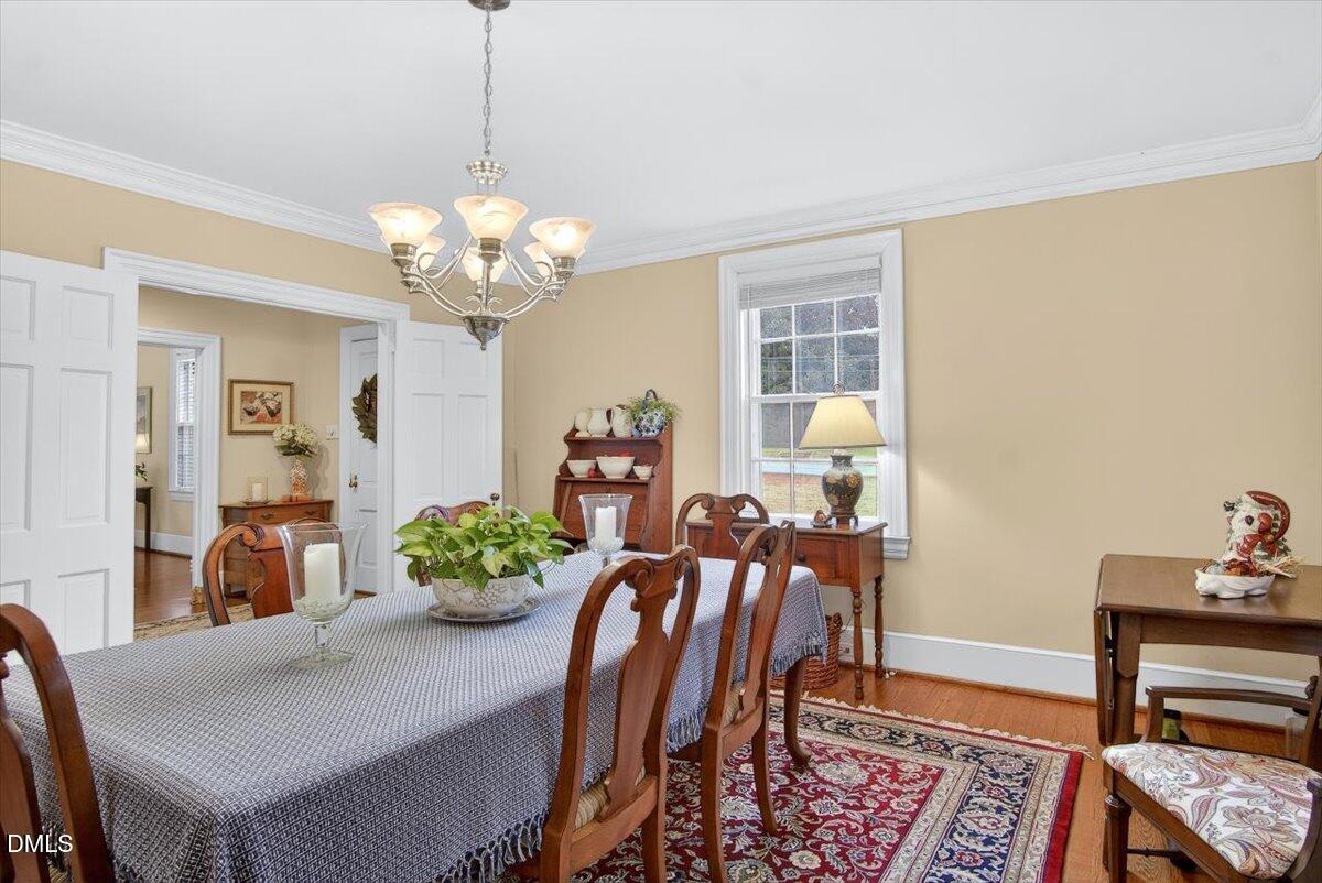 2064 Oxford Road Henderson, NC 27536 - Photo 9 of 68 a view of a dining room with furniture and a chandelier