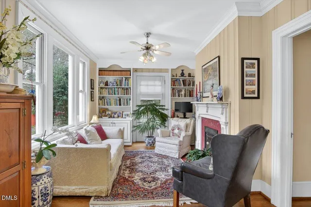 a living room with furniture a chandelier and a fireplace