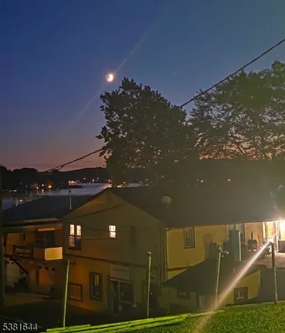 a yellow building with trees in front of it