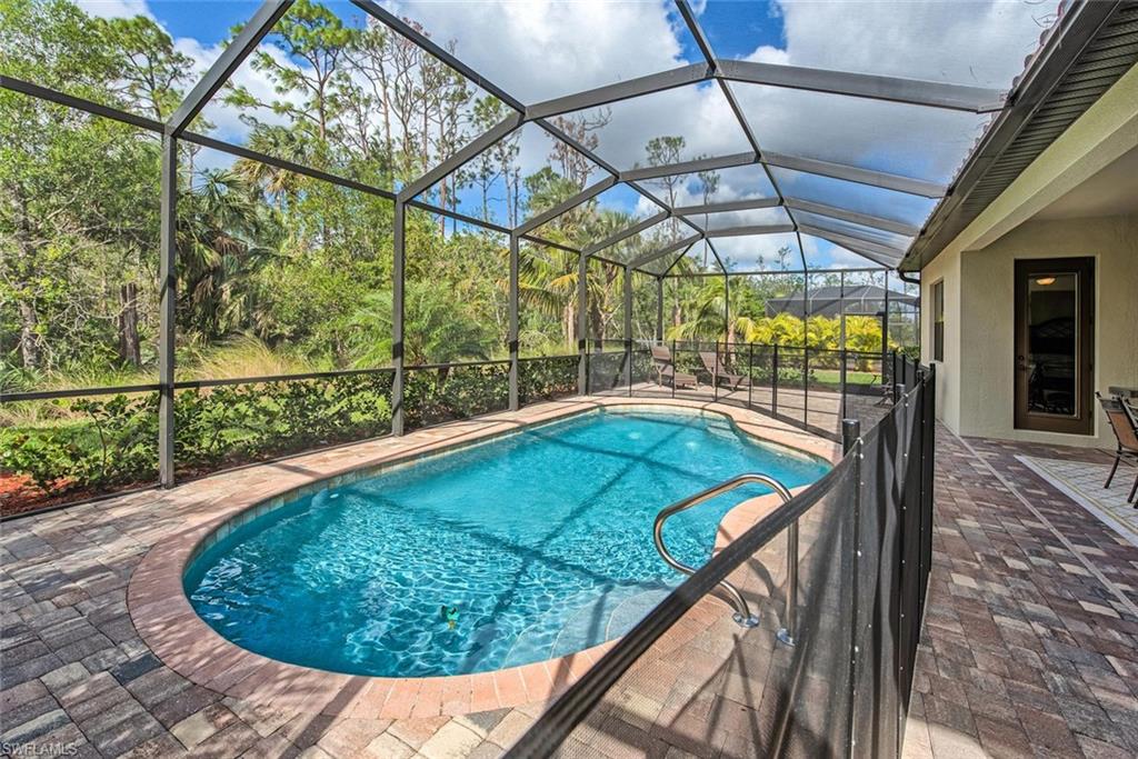 9387 Vercelli Court Naples, FL 34113 - Photo 1 of 25 a view of a indoor swimming pool