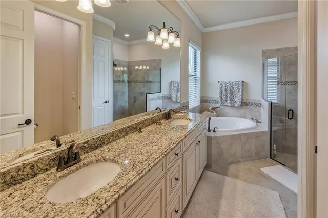 a bathroom with a granite countertop tub sink and mirror