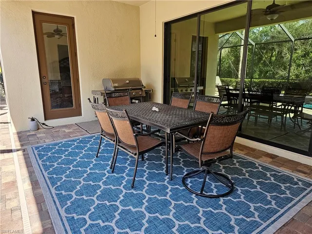 a view of an outdoor dining space with a table and chairs