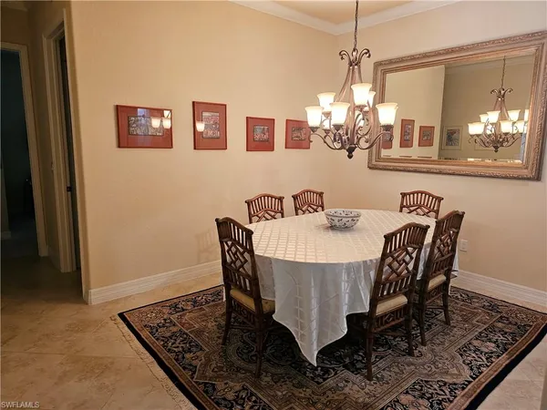 a view of a dining room with furniture and chandelier