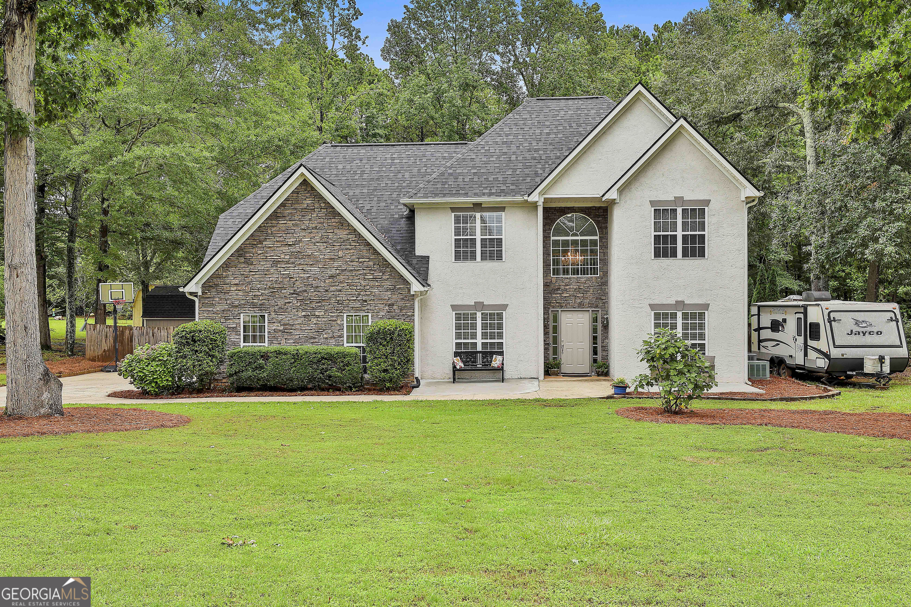 a front view of a house with a yard and garage
