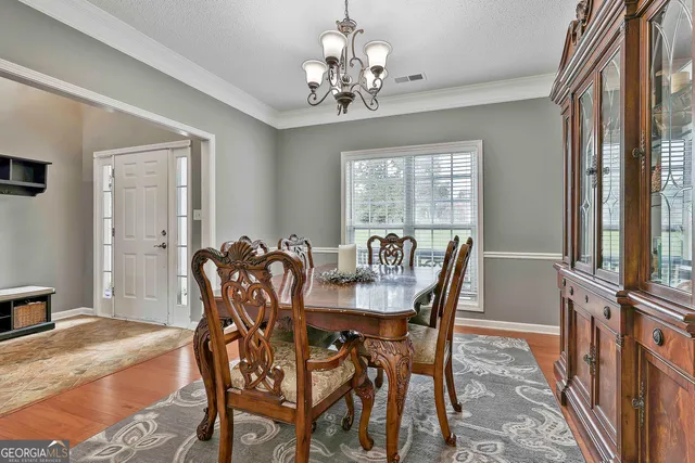 a living room with furniture and a dining table
