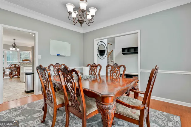a view of a a dining room with furniture window and wooden floor