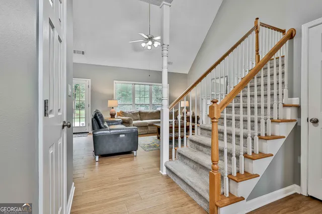a dining room with furniture a chandelier and window