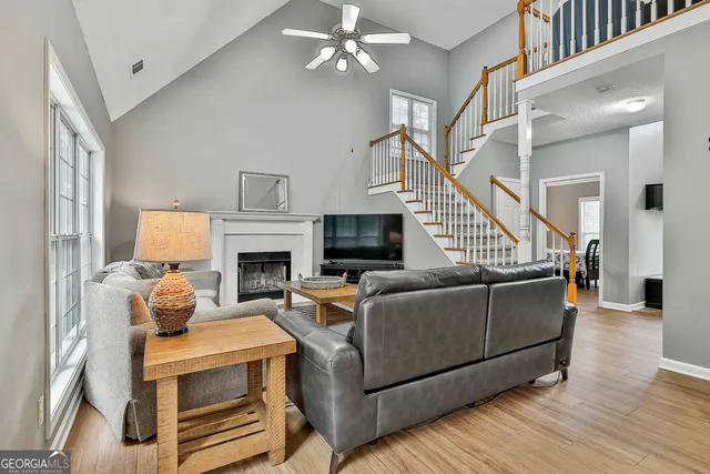 a dining room with furniture a chandelier and wooden floor
