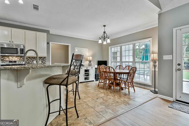 a kitchen with stainless steel appliances granite countertop a sink stove and cabinets