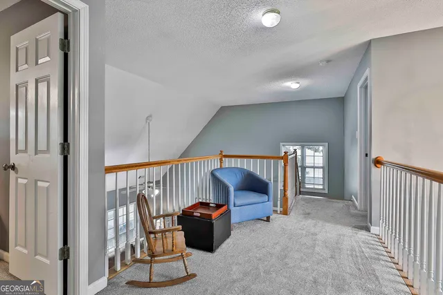 a view of a house with yard and sitting area