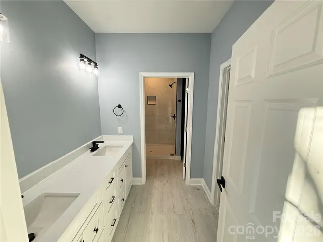 a bathroom with a double vanity sink and mirror