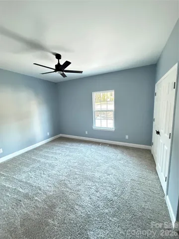 a view of a livingroom with a ceiling fan and window