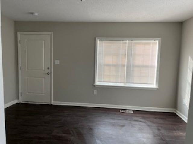 2060 Riverside Boulevard Memphis, TN 38109 - Photo 2 of 13 an empty room with wooden floor and windows