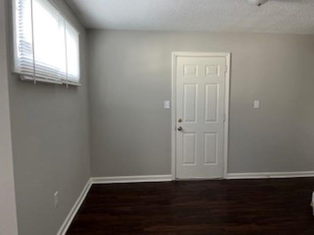 2060 Riverside Boulevard Memphis, TN 38109 - Photo 4 of 13 an empty room with wooden floor and windows