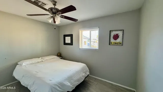 a bed sitting in a bedroom next to a window