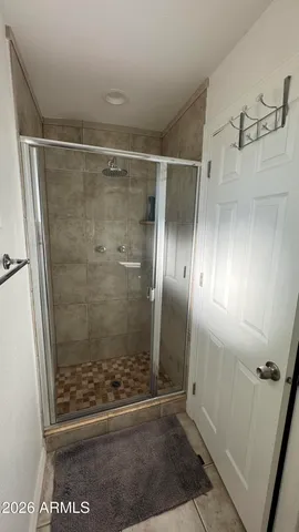 a bathroom with a glass shower door