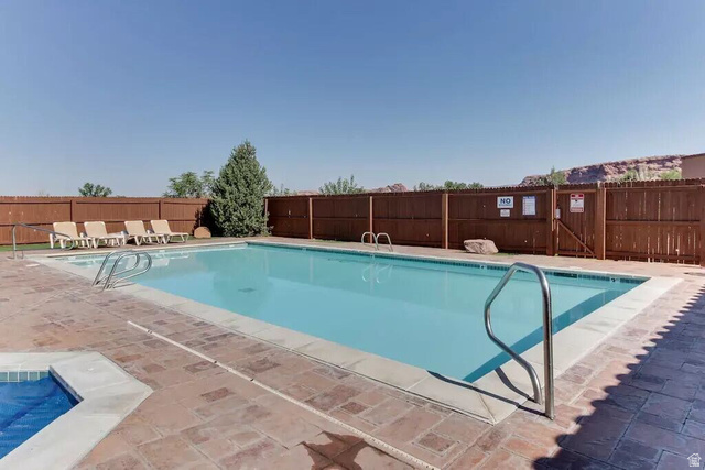 3853 South Red Valley Circle, Unit 22A1 Moab, UT 84532 - Photo 24 of 28 Community pool with a patio area and a gate
