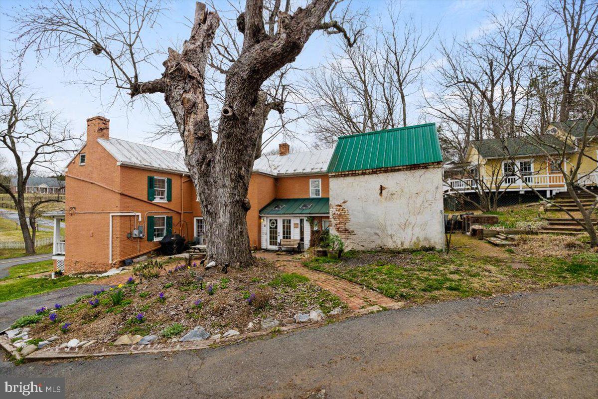 4781 Scrabble Road Shepherdstown, WV 25443 - Photo 18 of 61 a view of a white house with a large tree in front