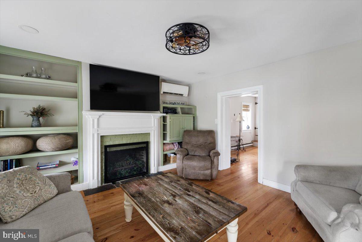 4781 Scrabble Road Shepherdstown, WV 25443 - Photo 22 of 61 a living room with furniture and a fireplace