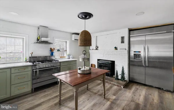 a view of a workspace with furniture and a fireplace