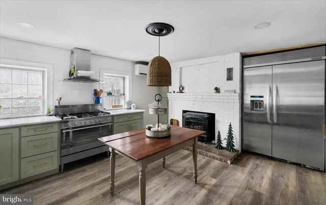 a view of a workspace with furniture and a fireplace