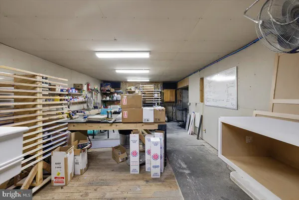 an aerial view of residential house with parking and yard
