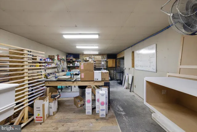 an aerial view of residential house with parking and yard