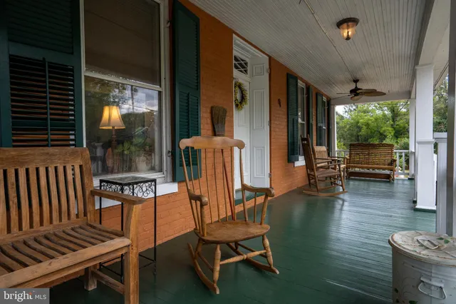 a building outdoor space with patio furniture and potted plants
