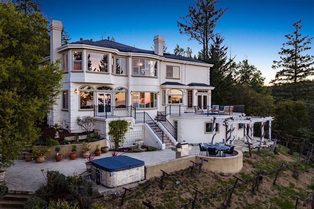 a front view of a house with garden and patio