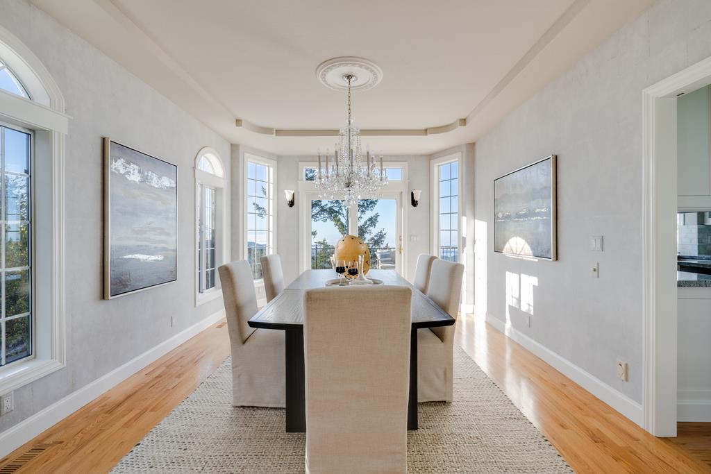 25220 Quail Ridge Road Los Gatos, CA 95033 - Photo 14 of 94 a dining room with wooden floor a chandelier a wooden table and chairs